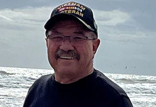 Peter Beckman standing by ocean.