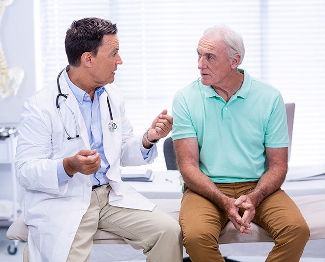 Doctor speaking with a patient during a consultation.